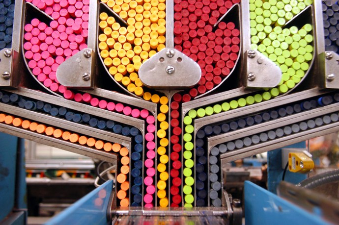 EASTON, PA - JUNE 18: A packaging machine sorts crayons while moving them towards individual boxes at Binney and Smith, Inc., the manufacturer of Crayola crayons June 18, 2003 in Easton, Pennsylvania. Binney and Smith, Inc. are celebrating the 100th anniversary of the first box of Crayola crayons. Introduced in 1903, a box of Crayola crayons sold for a nickel and included the same eight colors available today: red, blue, yellow, violet, orange, black, and brown. (Photo by William Thomas Cain/Getty Images)