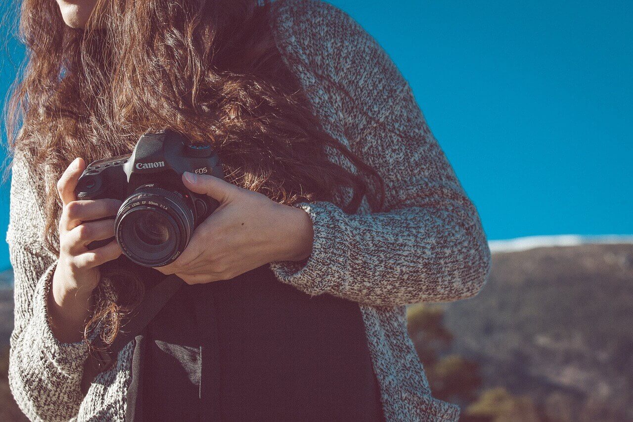 A woman holding a camera.